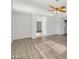 Open living area with white walls, modern flooring, ceiling fan, and ample natural light at 9247 Tulip Trestle Ave, Las Vegas, NV 89148