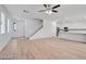 Open living area boasts light wood floors, multiple windows, and a modern ceiling fan for a bright, spacious feel at 9247 Tulip Trestle Ave, Las Vegas, NV 89148