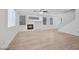 Open living area featuring wood floors, large windows, fireplace and staircase at 9247 Tulip Trestle Ave, Las Vegas, NV 89148