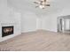 Inviting living room with a cozy fireplace and modern ceiling fan at 9247 Tulip Trestle Ave, Las Vegas, NV 89148