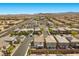 An aerial view of a residential neighborhood with nearby commercial centers and desert mountains in the distance at 9430 Isla Lee Ave, Las Vegas, NV 89178