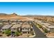 An aerial view of a neighborhood with similar single Gathering homes and desert mountains in the distance at 9430 Isla Lee Ave, Las Vegas, NV 89178