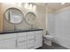 Stylish bathroom featuring double sinks, modern fixtures, and a bathtub with white tile surround at 9430 Isla Lee Ave, Las Vegas, NV 89178