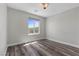 Bedroom featuring a modern ceiling light, neutral walls, and a window with a view at 9430 Isla Lee Ave, Las Vegas, NV 89178
