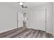 Bedroom with wood-look floors, ceiling fan and double sliding door closet at 9430 Isla Lee Ave, Las Vegas, NV 89178