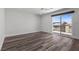 Modern bedroom with light walls, ceiling fan, and glass doors to balcony at 9430 Isla Lee Ave, Las Vegas, NV 89178