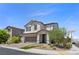 Lovely two-story home featuring desert landscaping and brick-paved driveway at 9430 Isla Lee Ave, Las Vegas, NV 89178