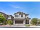 Charming two-story home featuring a manicured lawn and inviting two-car garage at 9430 Isla Lee Ave, Las Vegas, NV 89178