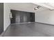 Epoxy floored garage with modern walls, water heater, and automatic door at 9430 Isla Lee Ave, Las Vegas, NV 89178