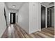 Hallway with wood floors and textured white walls leading to the front door at 9430 Isla Lee Ave, Las Vegas, NV 89178