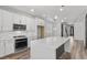Modern kitchen featuring stainless steel appliances, a center island, and sleek white cabinetry at 9430 Isla Lee Ave, Las Vegas, NV 89178