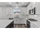 Well-lit kitchen showcasing white cabinets, stainless steel appliances, and stylish backsplash at 9430 Isla Lee Ave, Las Vegas, NV 89178
