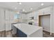 Bright kitchen features white cabinets, stainless steel appliances, and a spacious island with counter seating at 9430 Isla Lee Ave, Las Vegas, NV 89178