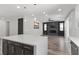Open floorplan featuring a kitchen island and living room with a modern fireplace and ceiling fan at 9430 Isla Lee Ave, Las Vegas, NV 89178