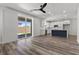 Bright living room with sliding glass doors, complemented by an open-concept kitchen and stylish flooring at 9430 Isla Lee Ave, Las Vegas, NV 89178