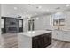 Open-concept kitchen with island, seamlessly connected to the living room with stylish decor and natural light at 9430 Isla Lee Ave, Las Vegas, NV 89178