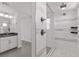 Spacious main bathroom featuring double shower, gray cabinets and white tiles at 9430 Isla Lee Ave, Las Vegas, NV 89178