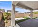 Covered patio with modern concrete support columns and a view of the landscaped backyard at 9430 Isla Lee Ave, Las Vegas, NV 89178