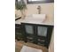 Bathroom vanity with a square sink, a black frame mirror, and storage at 9589 Comiskey Ct, Las Vegas, NV 89148