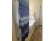 Freestanding tub and tiled shower with blue stripped shower curtain in tiled bathroom at 9589 Comiskey Ct, Las Vegas, NV 89148