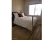 Bedroom with a bed, a cozy rug, and a sunlit window providing natural light at 9589 Comiskey Ct, Las Vegas, NV 89148
