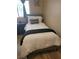 A cozy bedroom featuring a single bed with plush bedding and a decorative pillow at 9589 Comiskey Ct, Las Vegas, NV 89148