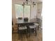 The dining area features a modern light fixture and a rustic wood table at 9589 Comiskey Ct, Las Vegas, NV 89148