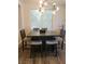 The dining area features a modern light fixture and a rustic wood table at 9589 Comiskey Ct, Las Vegas, NV 89148