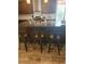 This kitchen features a large granite island with barstool seating at 9589 Comiskey Ct, Las Vegas, NV 89148