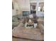 Cozy living room with comfortable seating, fireplace and view of the kitchen at 9589 Comiskey Ct, Las Vegas, NV 89148