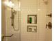 Tiled shower with shower head and built in shelving niche at 9589 Comiskey Ct, Las Vegas, NV 89148