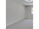 Simple bedroom with neutral carpet and white walls, illuminated by a modern ceiling fan at 9800 Rosamond Dr, Las Vegas, NV 89134