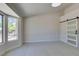 Bright bedroom with a bay window offering a view, and a sliding barn door at 9800 Rosamond Dr, Las Vegas, NV 89134