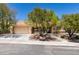 Inviting single-story home with a well-manicured front yard and a two-car garage at 9800 Rosamond Dr, Las Vegas, NV 89134