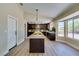 Bright kitchen with a large island, dark cabinetry, and ample counter space at 9800 Rosamond Dr, Las Vegas, NV 89134