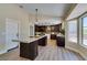 Modern kitchen features an island, wood cabinets, granite countertops, and stainless steel appliances at 9800 Rosamond Dr, Las Vegas, NV 89134