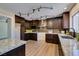 Modern kitchen with granite counters, dark wood cabinets, and stainless steel appliances at 9800 Rosamond Dr, Las Vegas, NV 89134