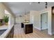 Open kitchen layout with granite countertops, a center island, and wood flooring throughout at 9800 Rosamond Dr, Las Vegas, NV 89134