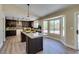 Modern kitchen featuring dark cabinets, stainless steel appliances, granite countertops, and a large window at 9800 Rosamond Dr, Las Vegas, NV 89134