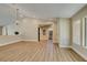 Bright living area featuring wood floors, neutral walls, and seamless transition to other rooms at 9800 Rosamond Dr, Las Vegas, NV 89134
