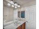 Bathroom with a marble countertop and a large mirror at 9893 Santa Ponsa Ct, Las Vegas, NV 89178
