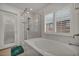 Modern bathroom with a marble tub and glass shower at 9893 Santa Ponsa Ct, Las Vegas, NV 89178