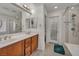 Bathroom with a dual sink vanity and marble countertop at 9893 Santa Ponsa Ct, Las Vegas, NV 89178