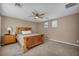 Cozy bedroom with a wooden bed frame, ceiling fan, and neutral-toned walls at 9893 Santa Ponsa Ct, Las Vegas, NV 89178