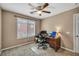 Neutral bedroom with bright window and office setup at 9893 Santa Ponsa Ct, Las Vegas, NV 89178
