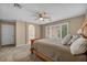 Bright bedroom with a wooden bed frame, large window and plush pillows at 9893 Santa Ponsa Ct, Las Vegas, NV 89178