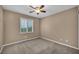 Simple bedroom with neutral carpet and a single window at 9893 Santa Ponsa Ct, Las Vegas, NV 89178