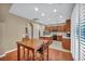 Spacious dining area with hardwood floors open to a kitchen with wood cabinets at 9893 Santa Ponsa Ct, Las Vegas, NV 89178