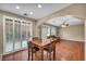 Open dining area with a wooden table set and natural light from the large sliding doors at 9893 Santa Ponsa Ct, Las Vegas, NV 89178