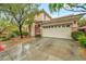 A spacious two-story home with a large garage and desert landscaping at 9893 Santa Ponsa Ct, Las Vegas, NV 89178
